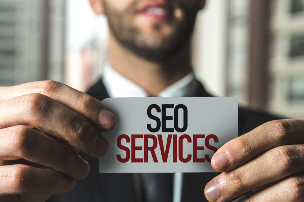 SEO Agency Representative holding an SEO Services sign representing Affordable SEO Services