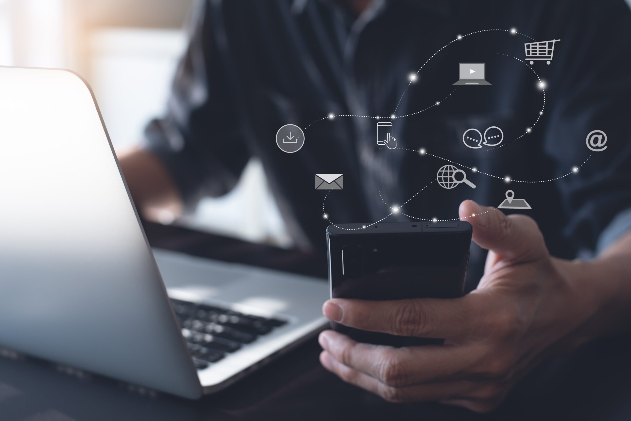 PPC Management Services by MWD - Man on Laptop with Phone in Hand Shopping Online